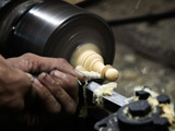 Artisan turning a wooden Chesspice
